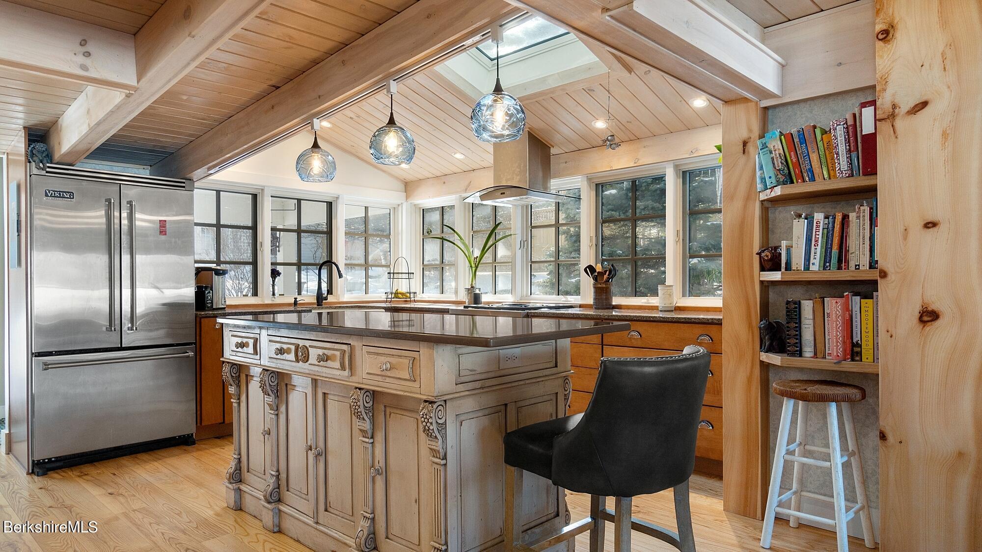 42 Lake Rd Extension Richmond, MA 01201 - Photo 12 of 47 a kitchen with stainless steel appliances granite countertop a table chairs and a refrigerator