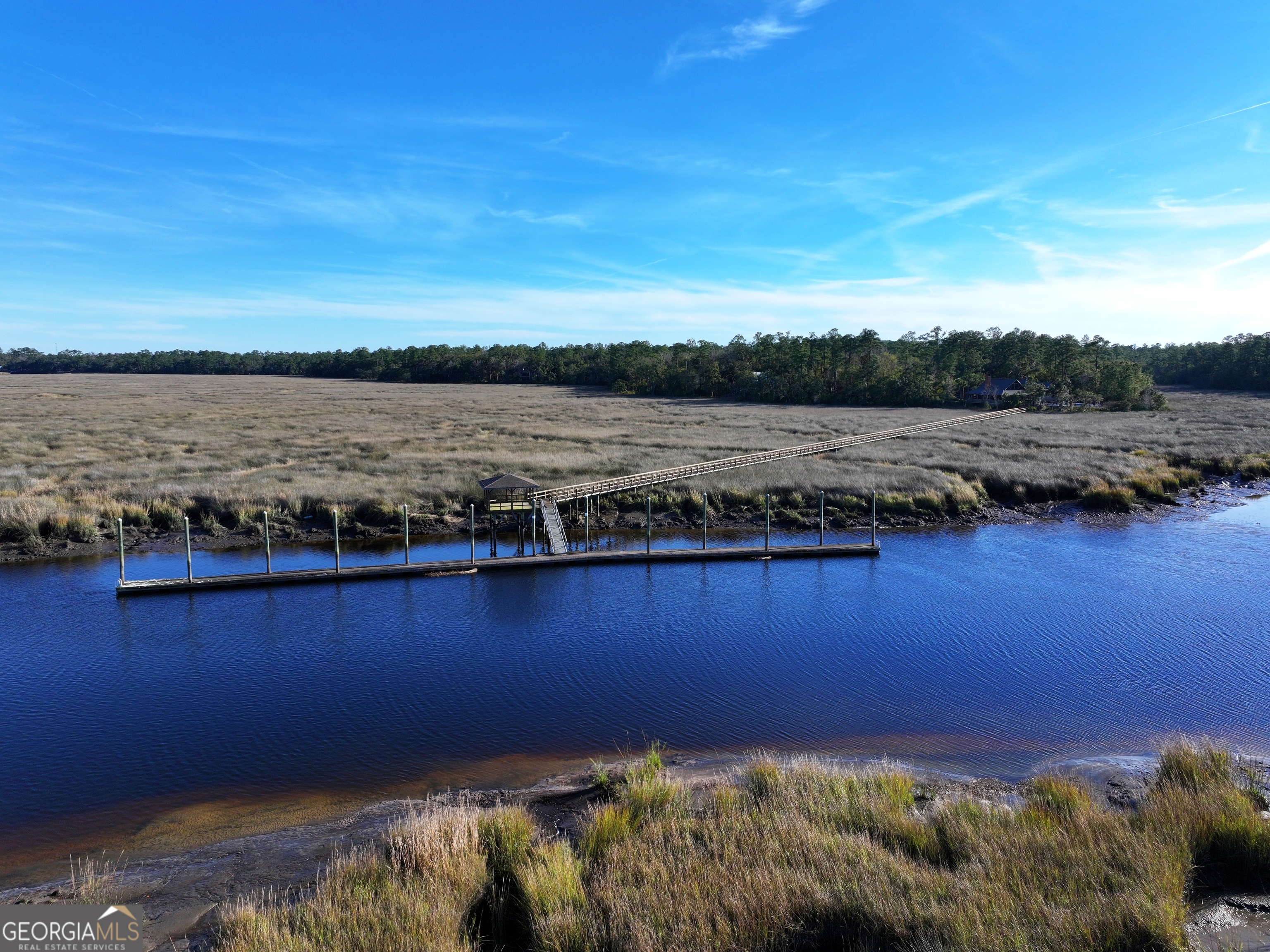 0 Merlin Court Waverly, GA 31565 - Photo 22 of 22 a view of a lake with houses in the back