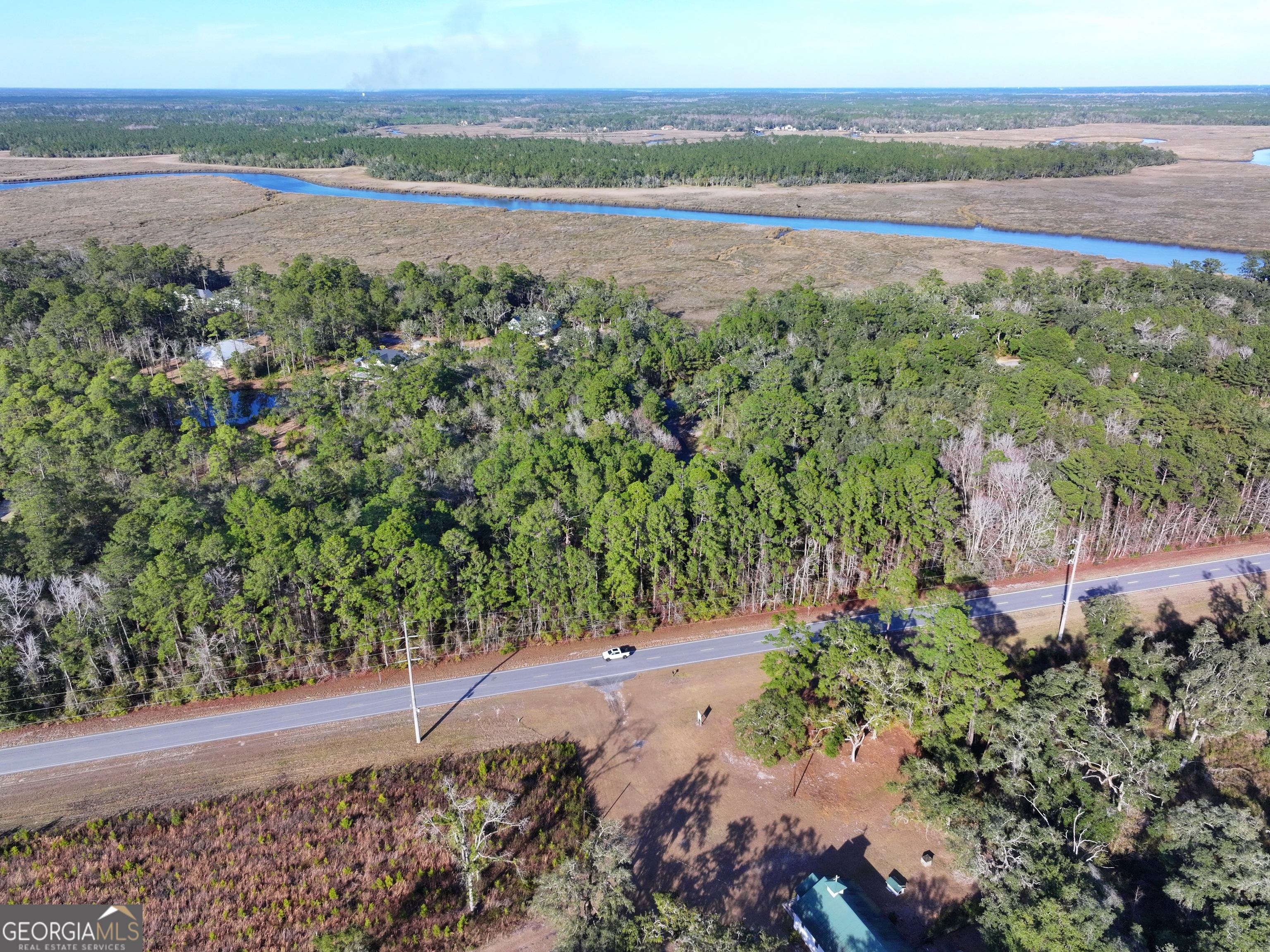 0 Merlin Court Waverly, GA 31565 - Photo 5 of 22 a view of a lake with a mountain in the background