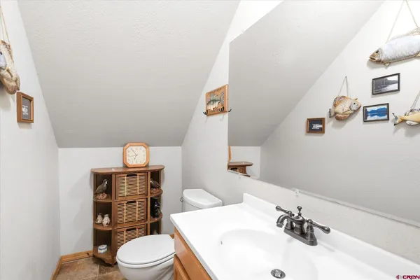 a bathroom with a sink vanity mirror and toilet