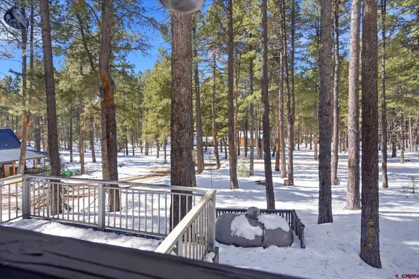 a view of a house with backyard and deck