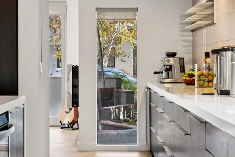 a large kitchen with a table and chairs