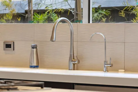 a kitchen with stainless steel appliances kitchen island granite countertop a stove and a sink