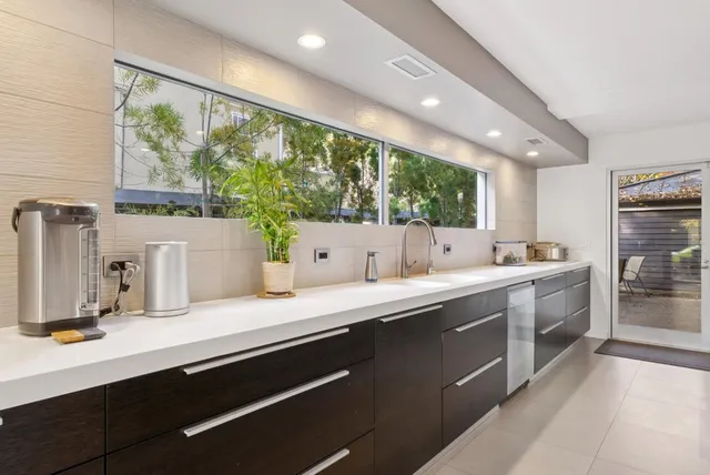 a living room with large window and a flat screen tv
