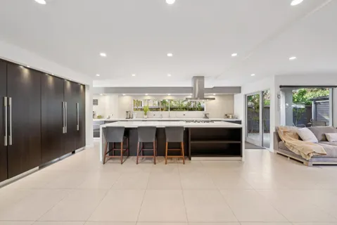 a lobby with a flat screen tv and a potted plant