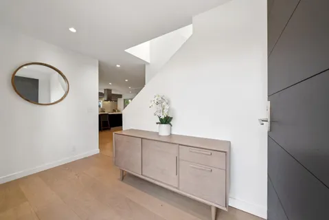 a living room with a couch and a large window with outer view