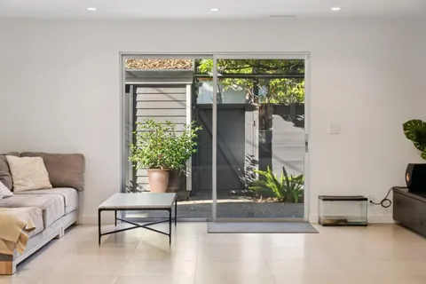 a view of a living room with furniture and a chandelier