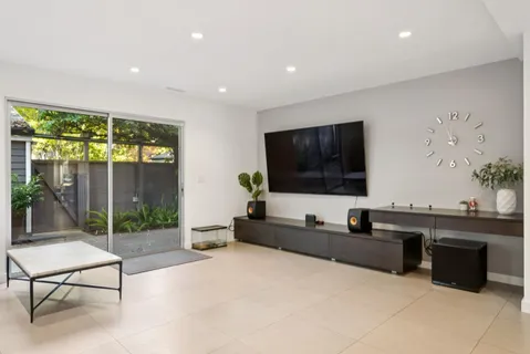 a view of a livingroom with furniture and a flat screen tv