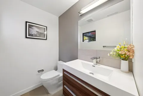 a view of a livingroom with workspace and a window