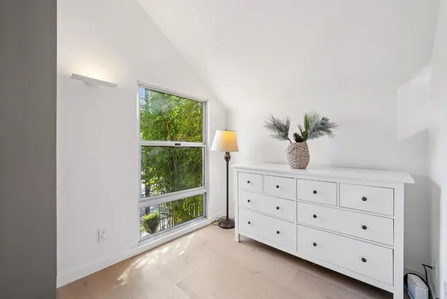 a bedroom with bed and a flat screen tv
