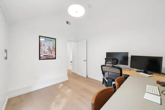 a view of a building with a wooden fence