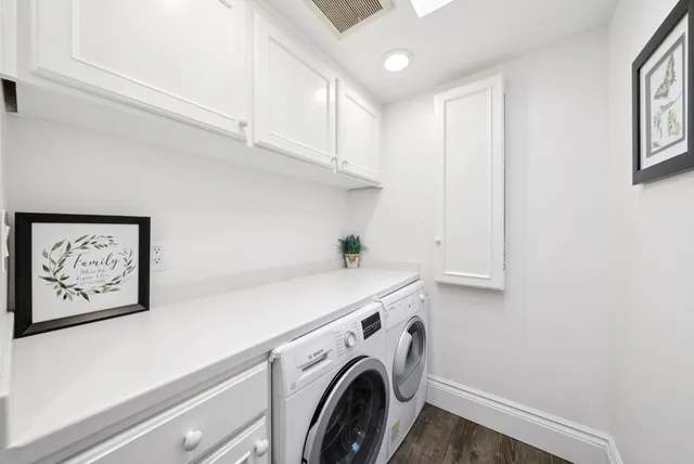 a view of a room with a large window and sitting area