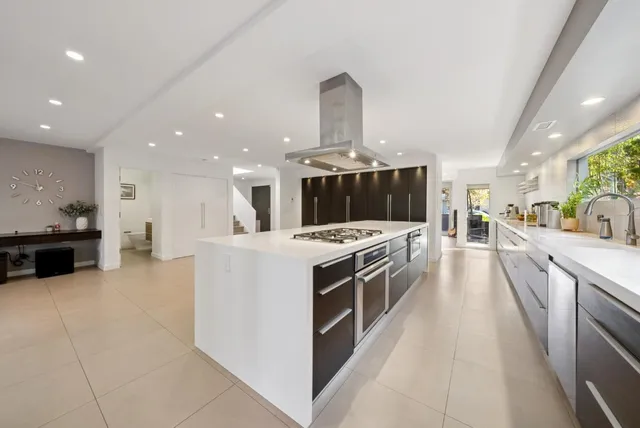 a kitchen with stainless steel appliances a sink and a refrigerator