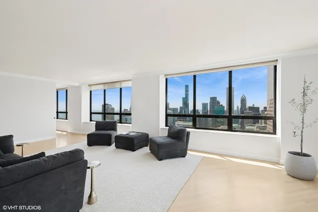 a living room with furniture a large window and a flat screen tv
