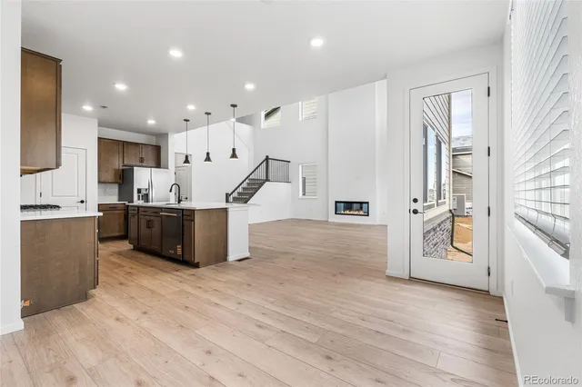 a kitchen with stainless steel appliances a refrigerator and a microwave