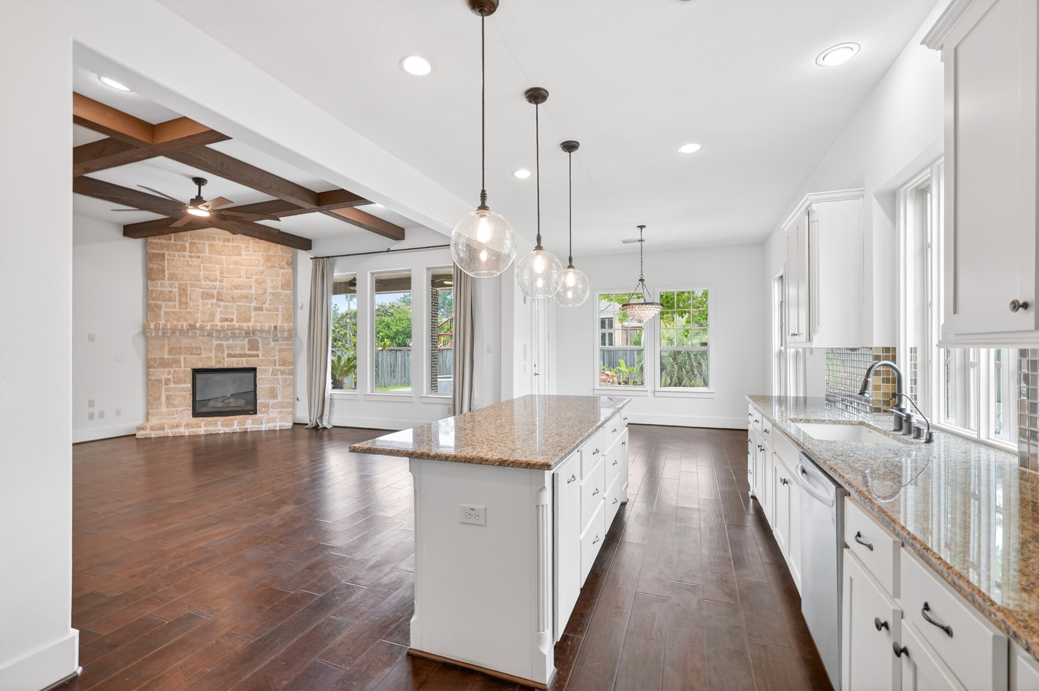 27 Hedgedale Way Spring, TX 77389 - Photo 19 of 49 a large kitchen with kitchen island a large window a sink and a chandelier