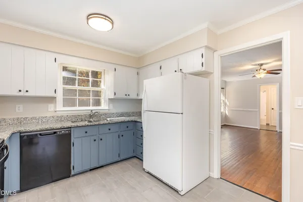a kitchen with a refrigerator a sink and cabinets