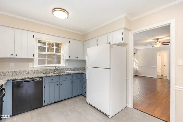 a kitchen with a refrigerator a sink and cabinets