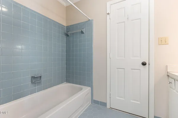 a bathroom with a bathtub and shower
