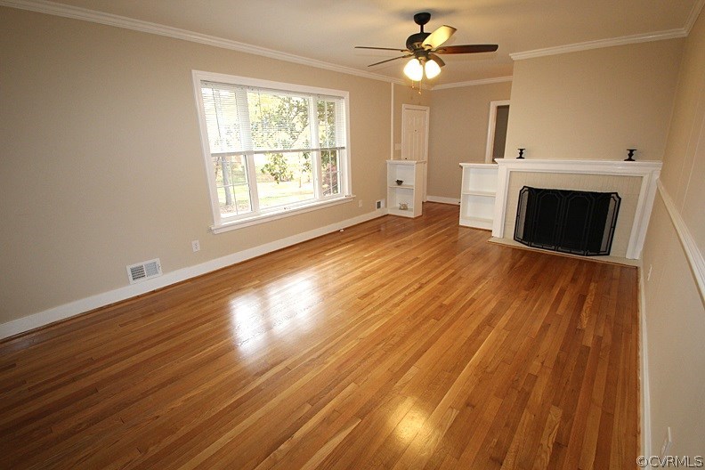 7539 Cherokee Road Richmond, VA 23225 - Photo 9 of 34 a view of empty room with wooden floor and fan