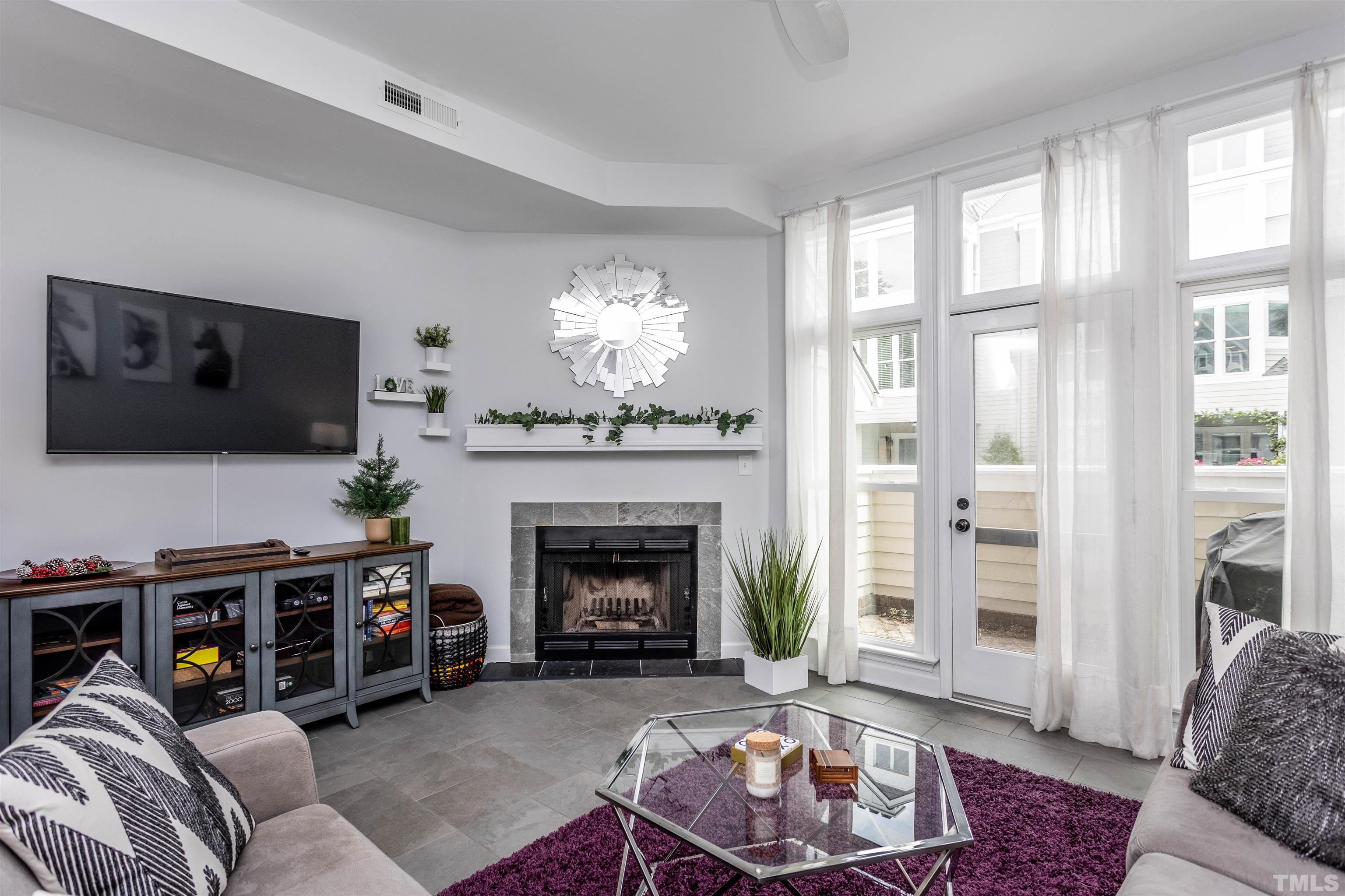 1024 Brighthurst Drive, Unit 1024 Raleigh, NC 27605 - Photo 13 of 30 a living room with furniture and a fireplace