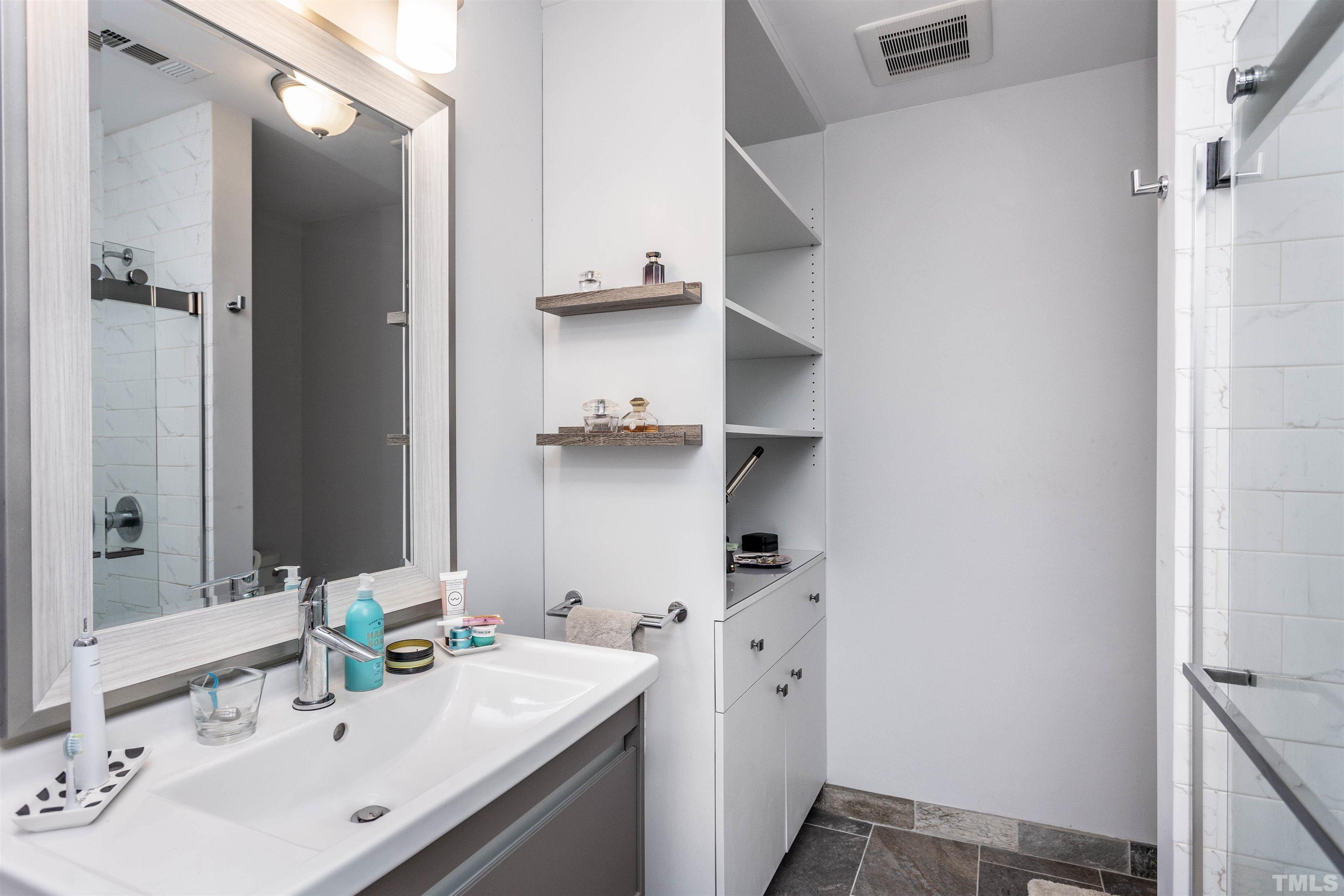 1024 Brighthurst Drive, Unit 1024 Raleigh, NC 27605 - Photo 20 of 30 a bathroom with a sink and mirror
