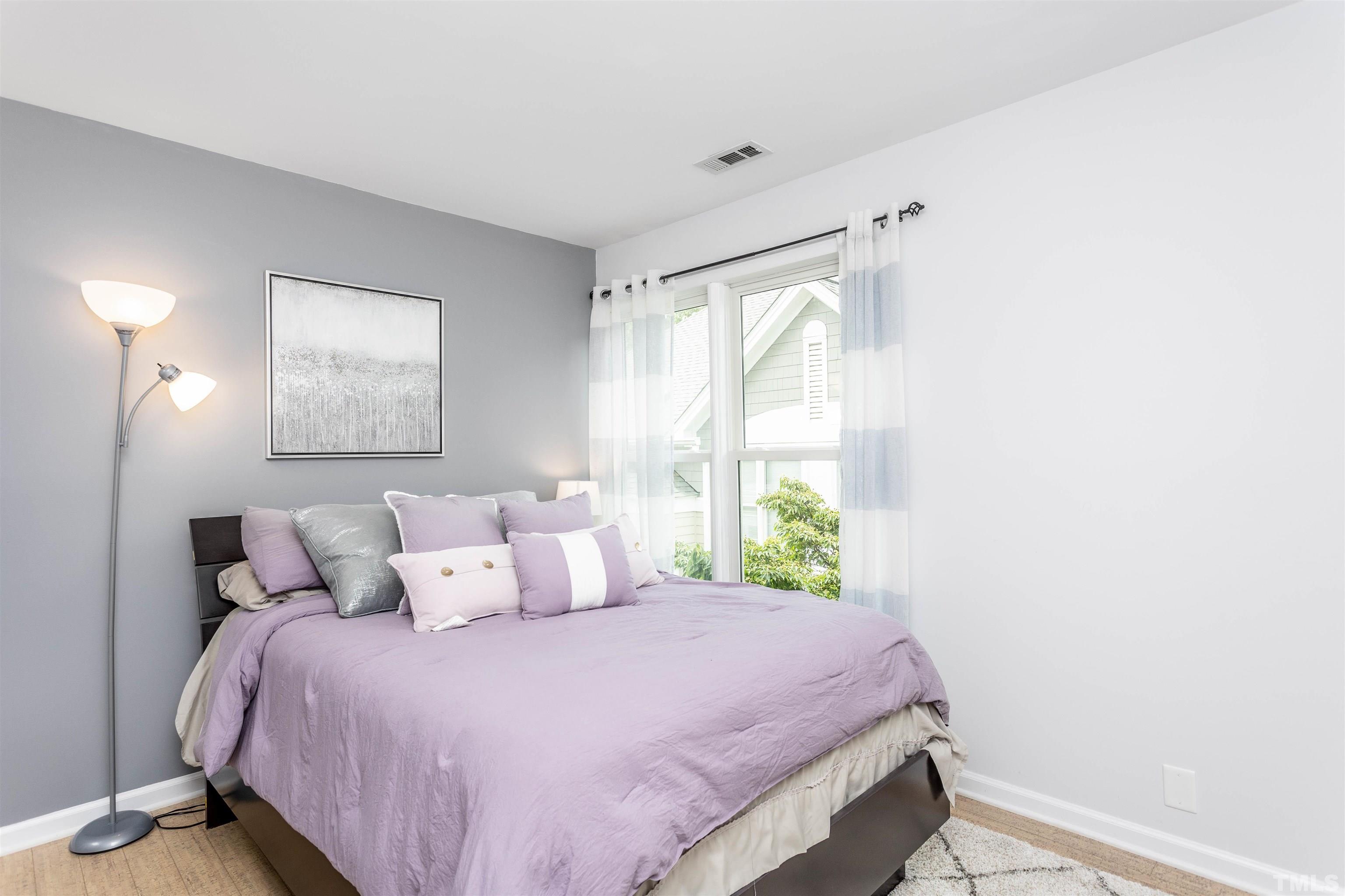 1024 Brighthurst Drive, Unit 1024 Raleigh, NC 27605 - Photo 22 of 30 a bedroom with a bed and a window