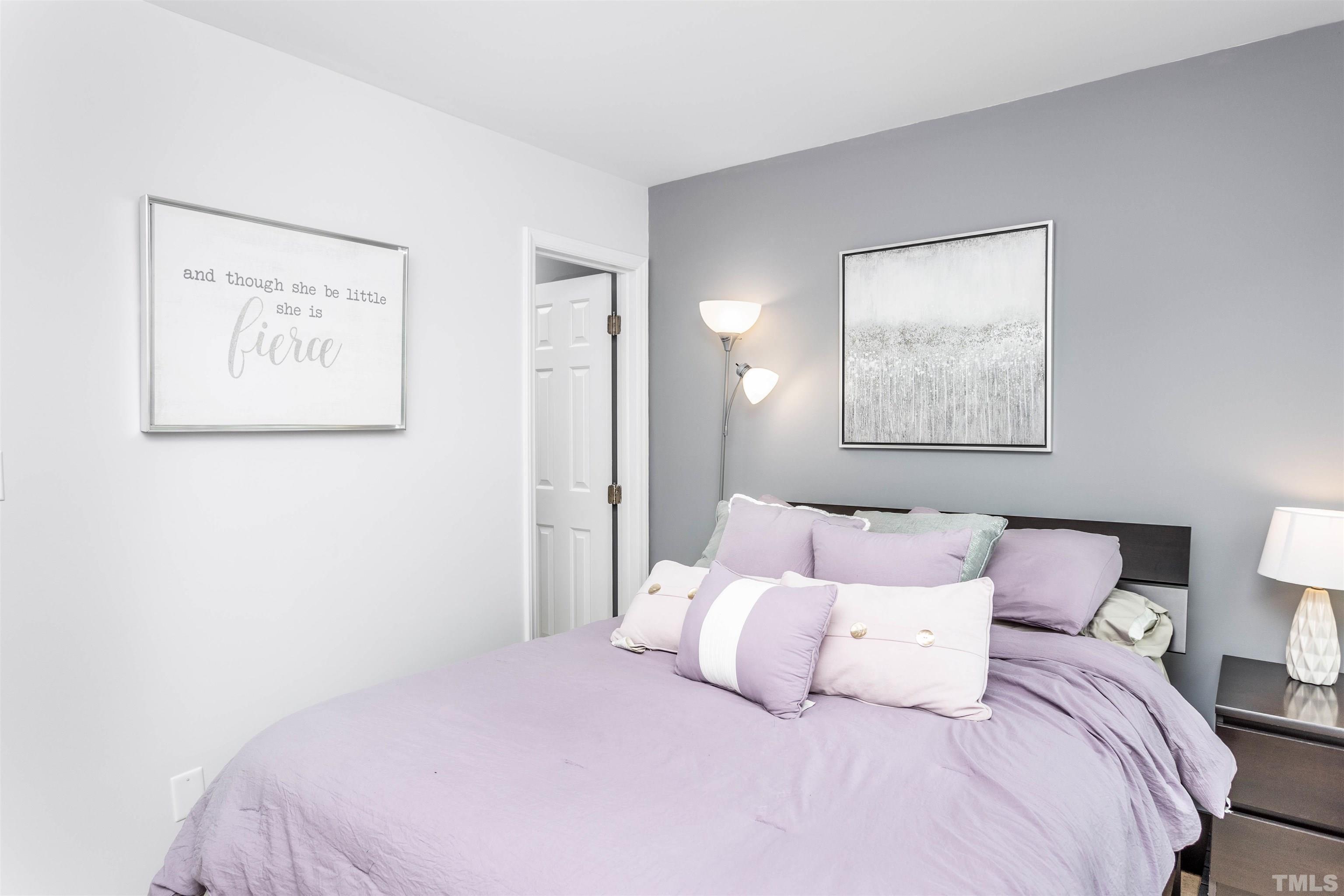 1024 Brighthurst Drive, Unit 1024 Raleigh, NC 27605 - Photo 23 of 30 a bedroom with a bed and a painting on the wall
