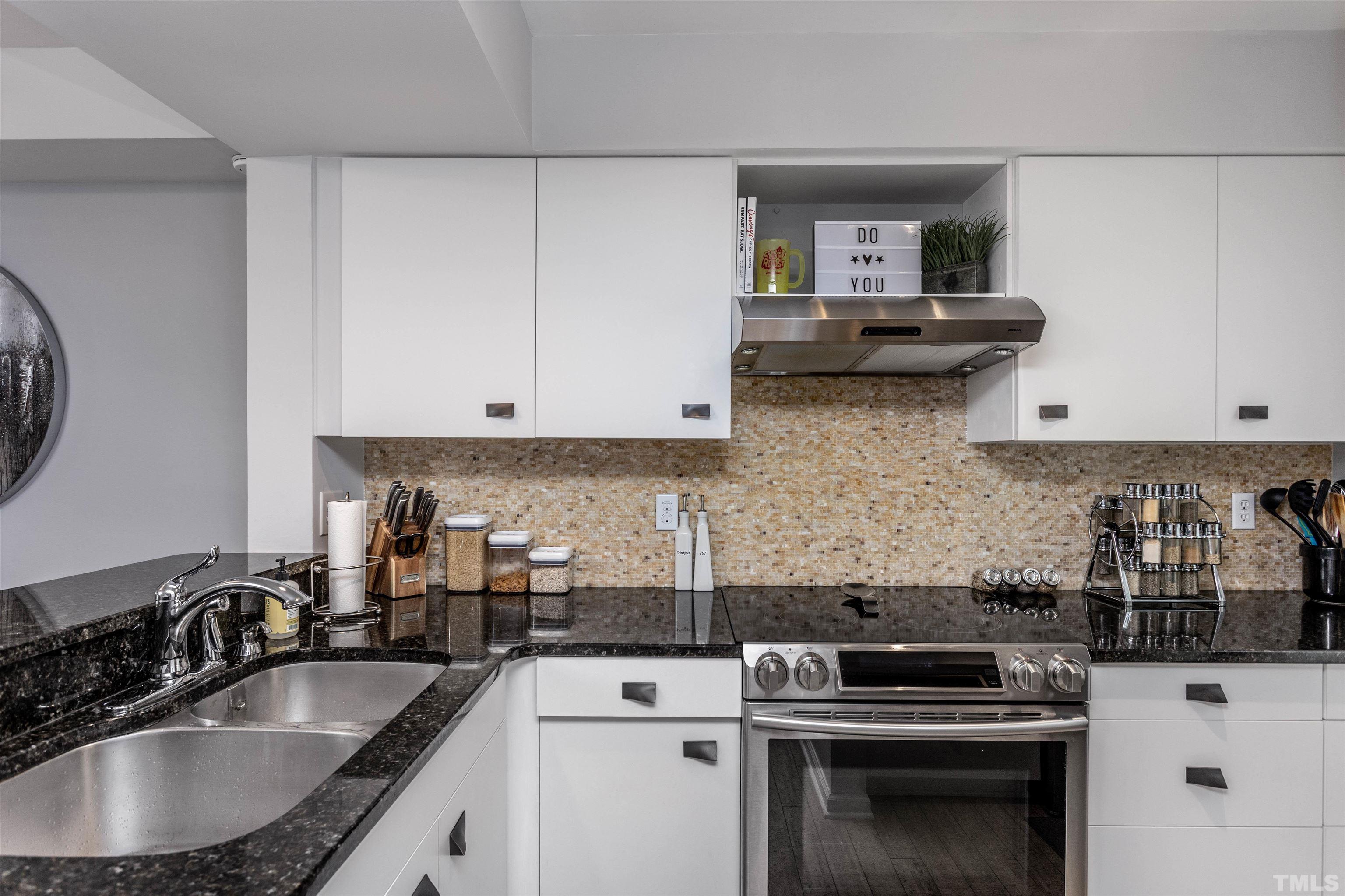 1024 Brighthurst Drive, Unit 1024 Raleigh, NC 27605 - Photo 4 of 30 a kitchen with granite countertop a sink stove and cabinets
