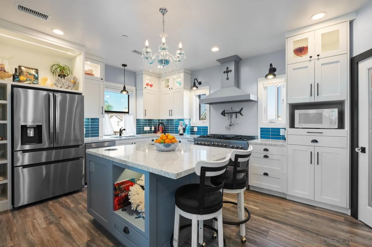 413 Delaware Street Imperial Beach, CA 91932 - Photo 14 of 37 a kitchen with stainless steel appliances a stove refrigerator sink and cabinets
