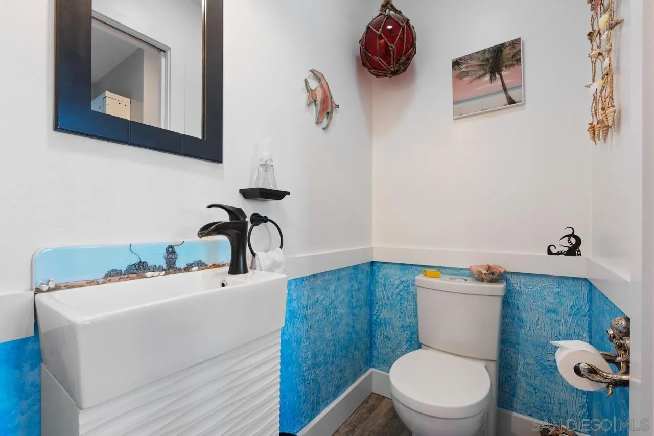 413 Delaware Street Imperial Beach, CA 91932 - Photo 21 of 37 a bathroom with a toilet sink and mirror