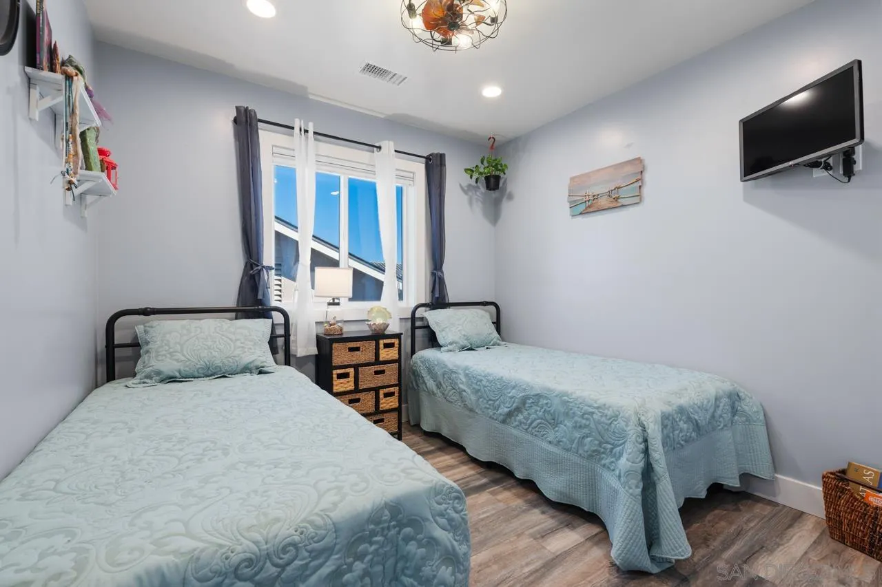 413 Delaware Street Imperial Beach, CA 91932 - Photo 22 of 37 a bedroom with two beds and a flat screen tv