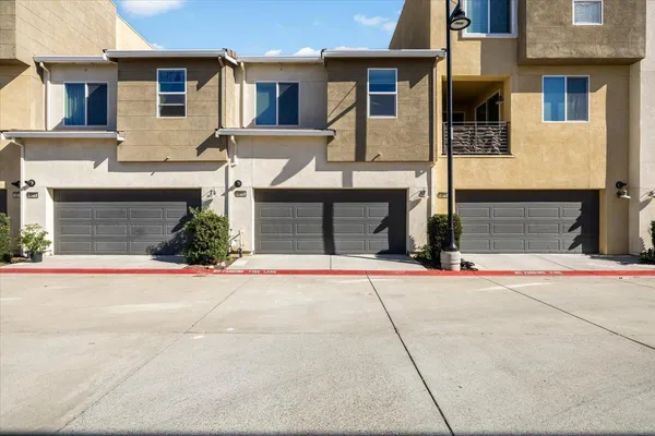 a front view of a house with a yard and a garage