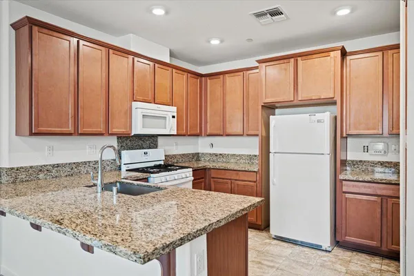a kitchen with a stove sink and cabinets