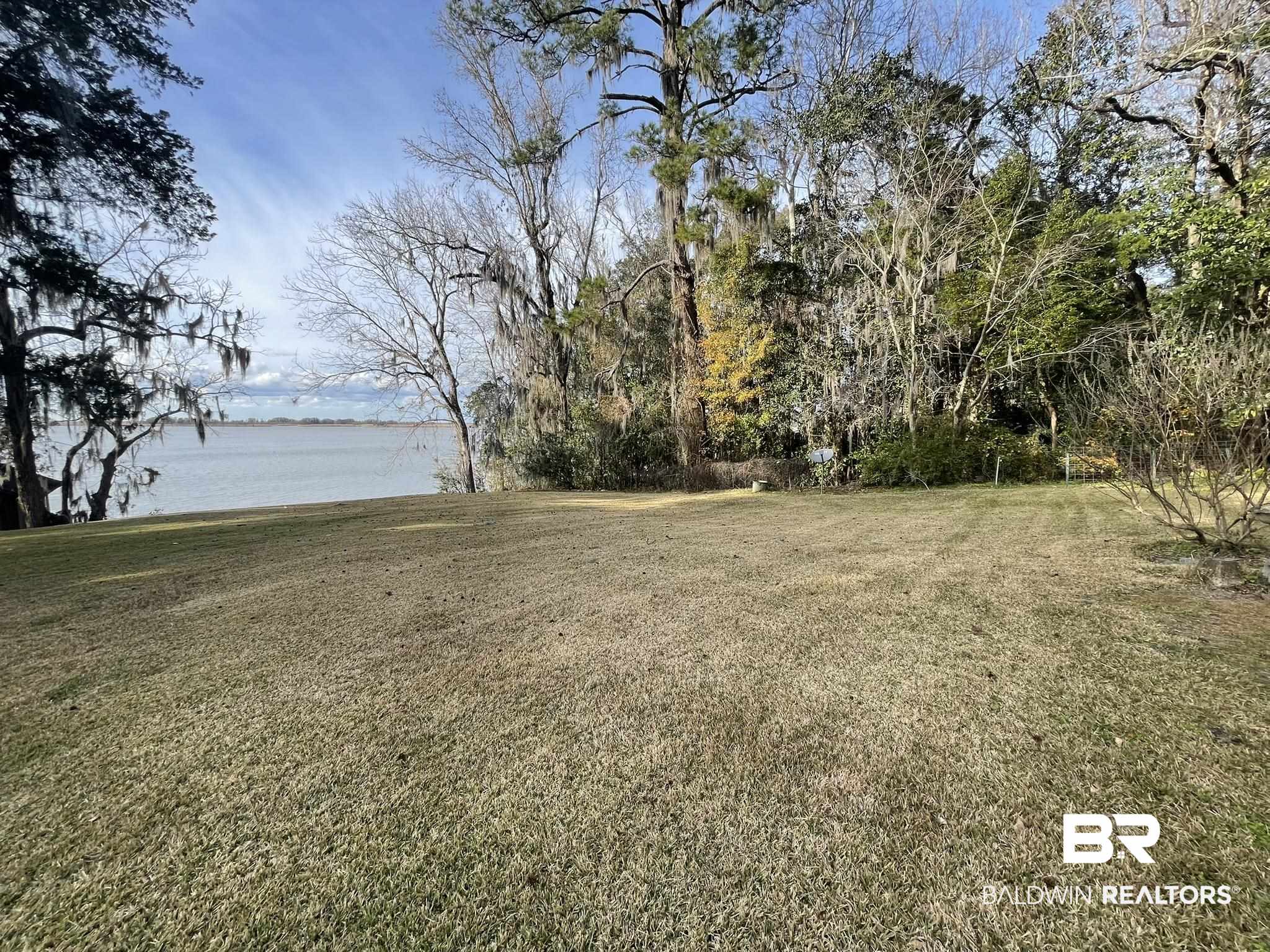6621 Purvis Road Daphne, AL 36527 - Photo 9 of 59 View of green lawn featuring a water view