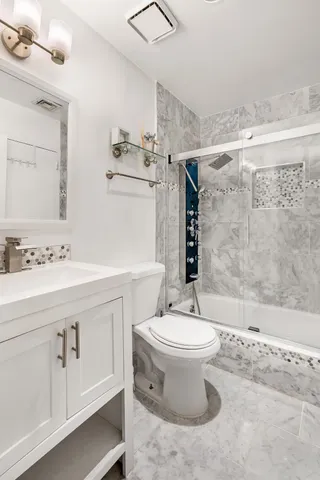 a bathroom with a sink toilet and shower