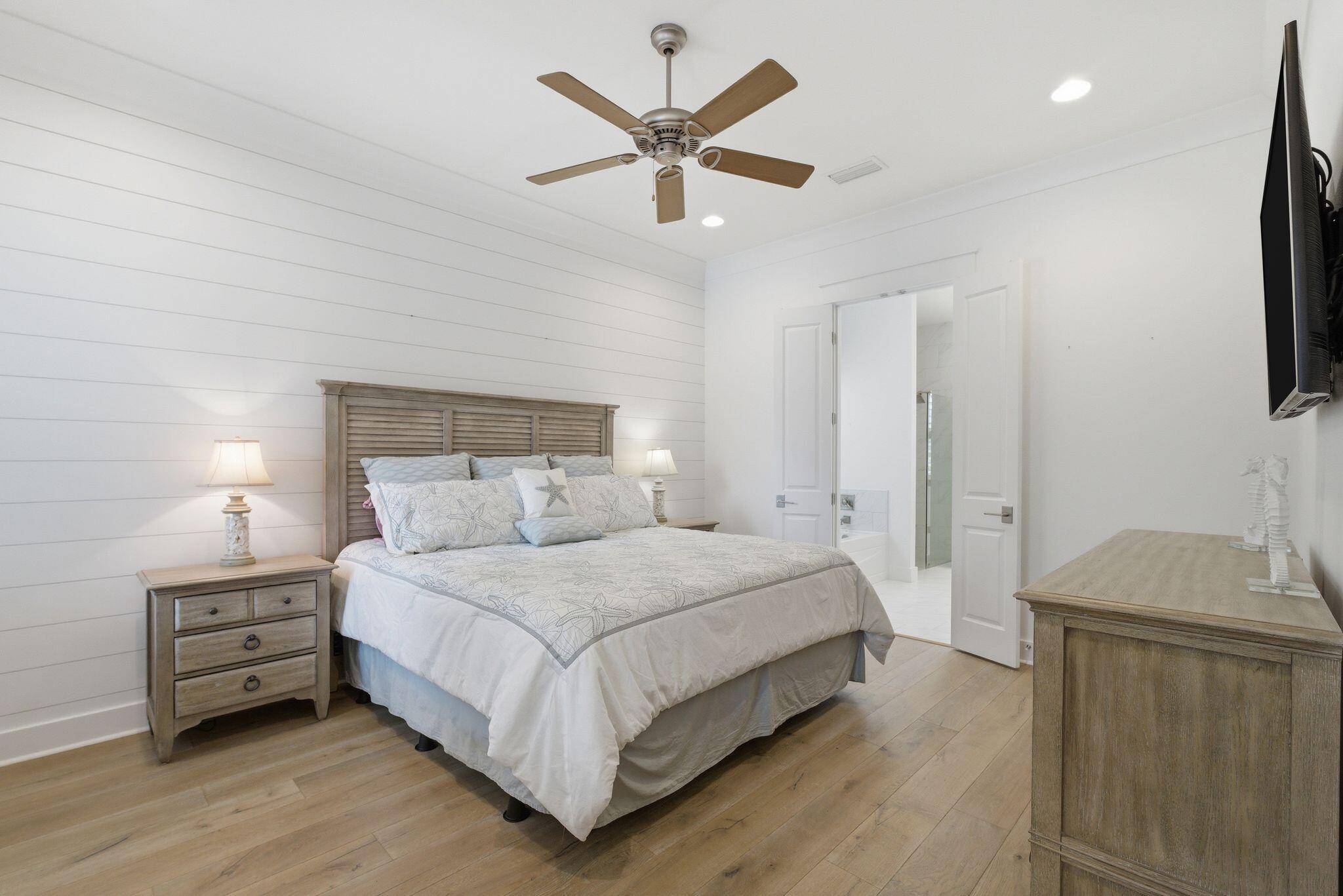 133 Sandchase Circle, Unit LOT 15 Inlet Beach, FL 32461 - Photo 14 of 47 a bedroom with a bed and a ceiling fan