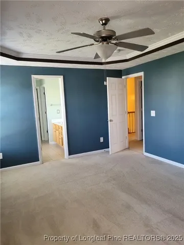 a view of a livingroom with a chandelier fan and a window