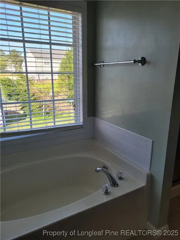 a bathroom with a bathtub and a window