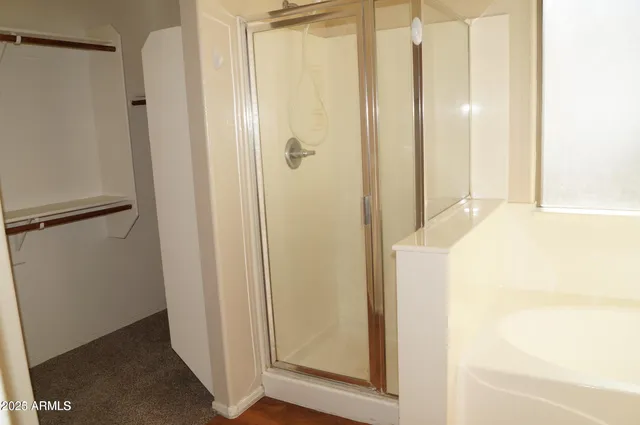 a bathroom with a shower and a glass door