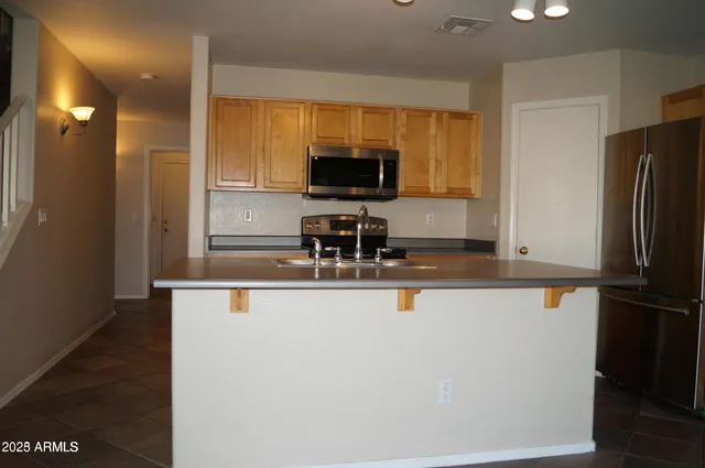 a kitchen with a refrigerator and a sink