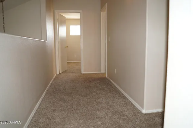 a view of a room with a hallway