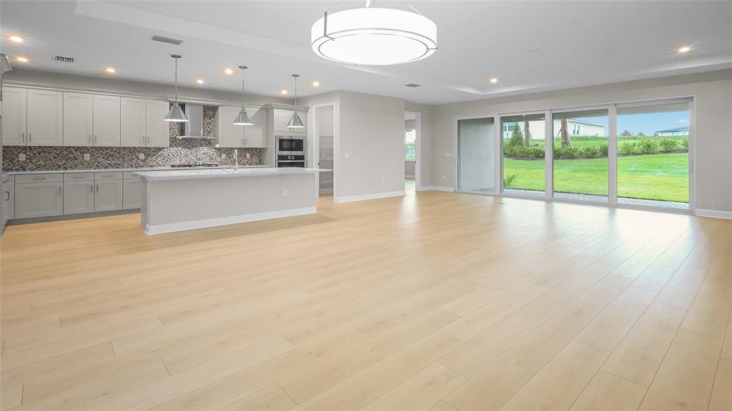 1620 Bellagio Loop Tavares, FL 32778 - Photo 12 of 81 a large kitchen with stainless steel appliances granite countertop a granite counter tops and a large window