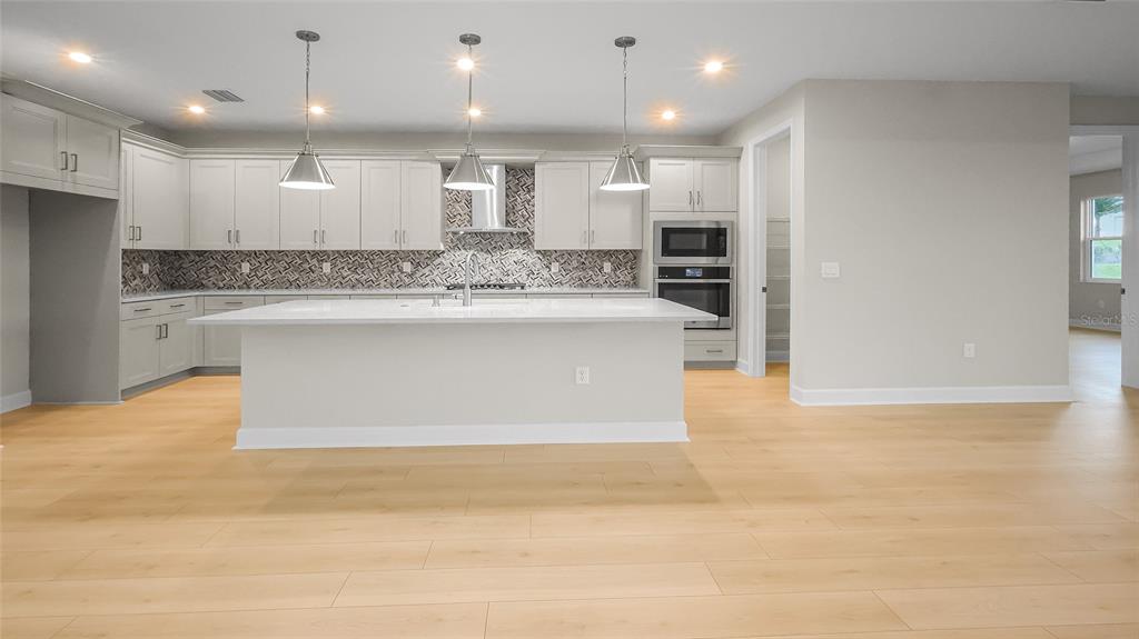 1620 Bellagio Loop Tavares, FL 32778 - Photo 16 of 81 a view of kitchen with kitchen island and stainless steel appliances