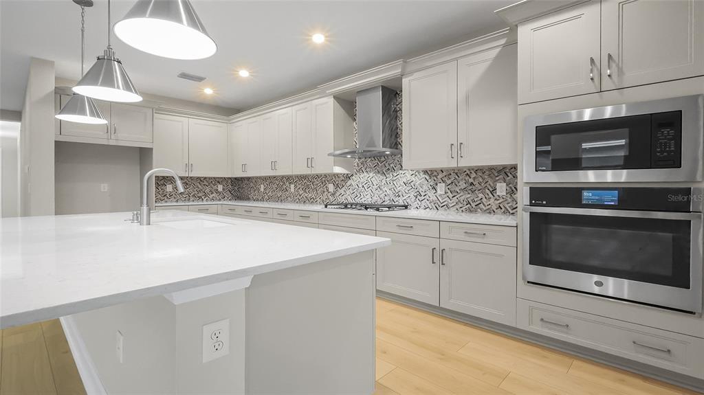 1620 Bellagio Loop Tavares, FL 32778 - Photo 19 of 81 a kitchen with stainless steel appliances granite countertop a sink and a stove