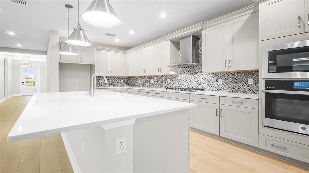 1620 Bellagio Loop Tavares, FL 32778 - Photo 20 of 81 a kitchen with stainless steel appliances kitchen island granite countertop a sink and cabinets