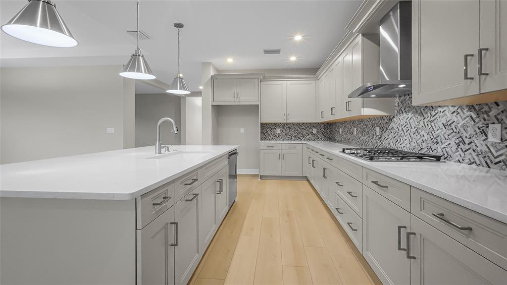 1620 Bellagio Loop Tavares, FL 32778 - Photo 26 of 81 a large white kitchen with a sink and dishwasher a stove with wooden floor