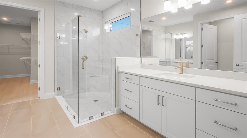 1620 Bellagio Loop Tavares, FL 32778 - Photo 34 of 81 a bathroom with a double vanity sink mirror and shower