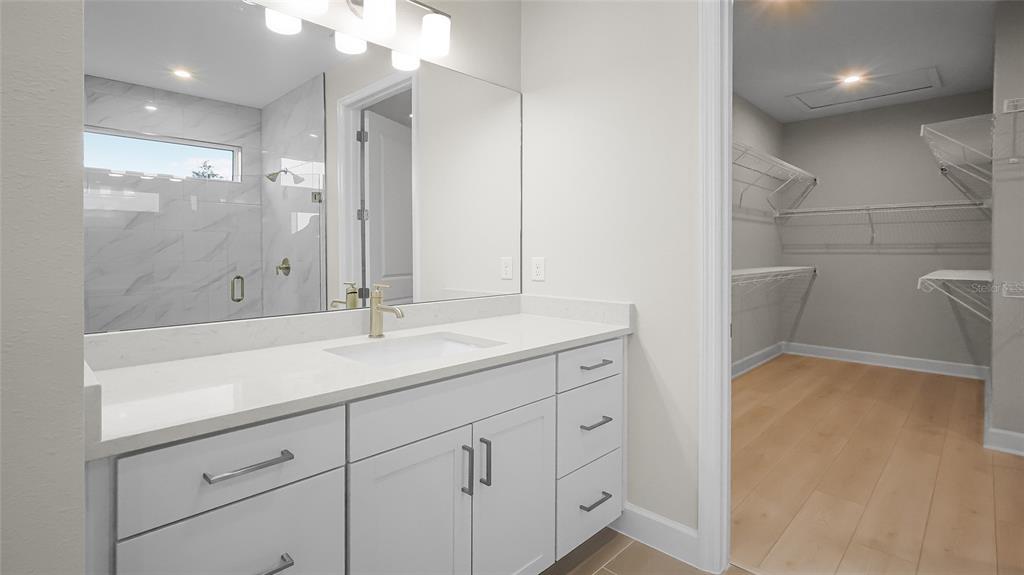 1620 Bellagio Loop Tavares, FL 32778 - Photo 36 of 81 a bathroom with a double vanity sink and a mirror