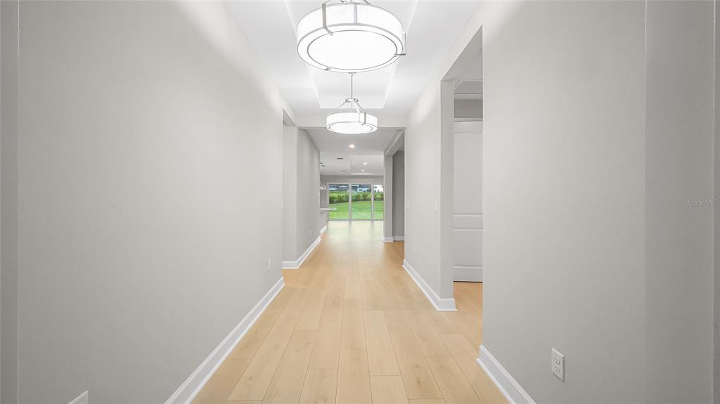 1620 Bellagio Loop Tavares, FL 32778 - Photo 4 of 81 a view of a room with wooden floor and white walls